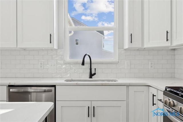 kitchen featuring white cabinetry, tasteful backsplash, and sink