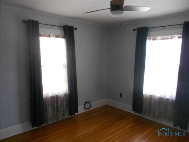 empty room with ceiling fan and wood-type flooring