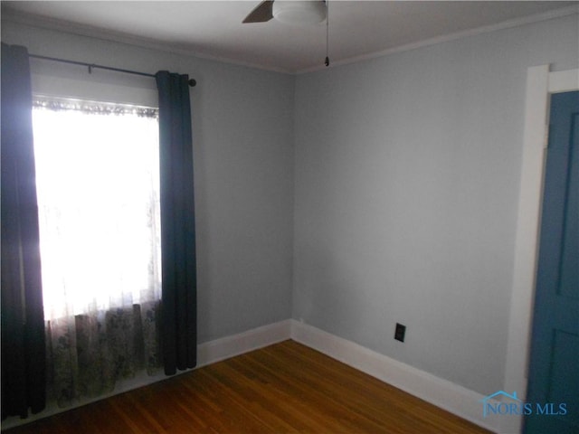 unfurnished room featuring ceiling fan, hardwood / wood-style flooring, ornamental molding, and a healthy amount of sunlight