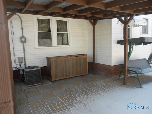 view of patio featuring a jacuzzi and cooling unit