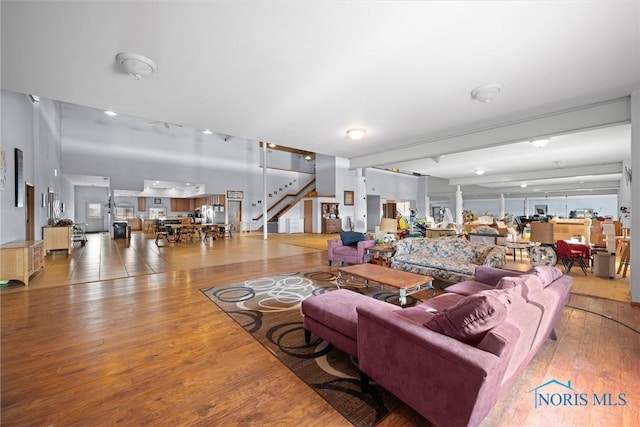 living room featuring hardwood / wood-style floors and decorative columns