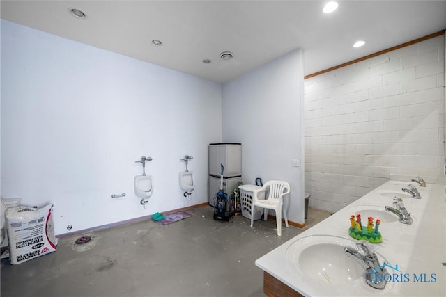 bathroom featuring vanity and concrete flooring