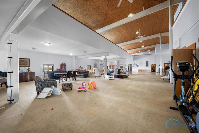 misc room featuring a towering ceiling, wooden ceiling, and ceiling fan