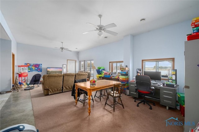 dining space with ceiling fan and carpet flooring