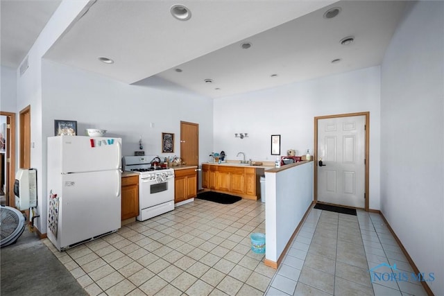 kitchen featuring sink, white appliances, kitchen peninsula, and light tile patterned floors