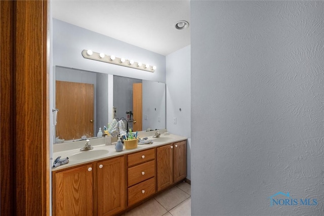 bathroom with tile patterned flooring and vanity