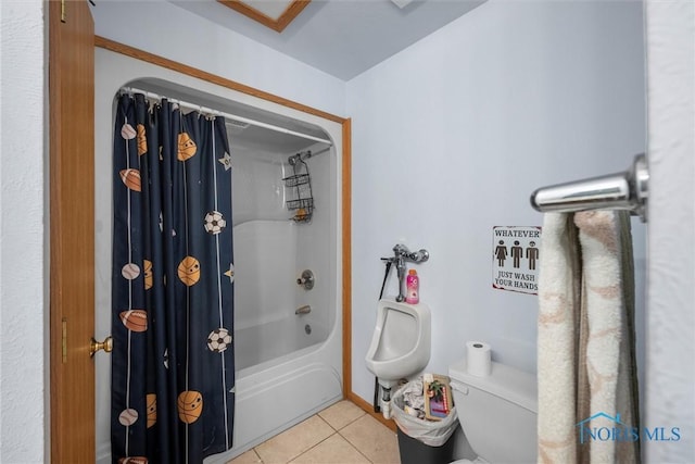 bathroom featuring tile patterned flooring, toilet, and shower / bath combo