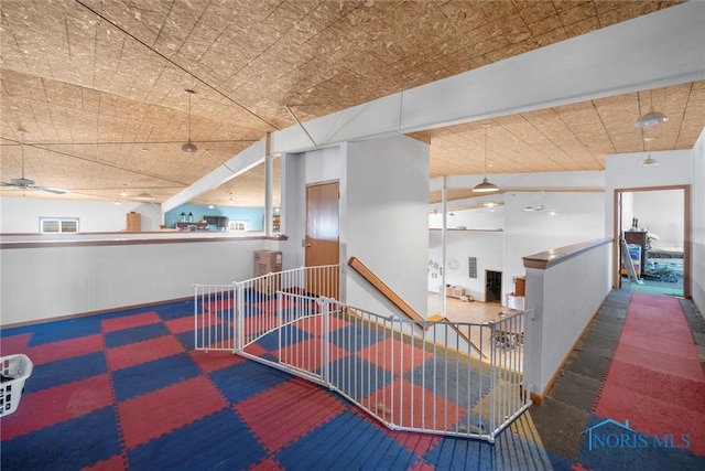 interior space featuring ceiling fan and vaulted ceiling