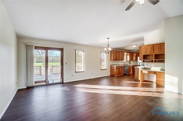 kitchen featuring vaulted ceiling, stainless steel dishwasher, ceiling fan with notable chandelier, hanging light fixtures, and dark hardwood / wood-style floors