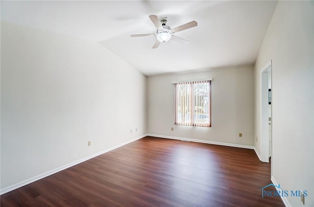 unfurnished room with ceiling fan, vaulted ceiling, and dark hardwood / wood-style floors