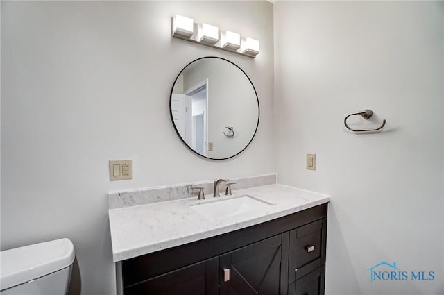 bathroom featuring toilet and vanity