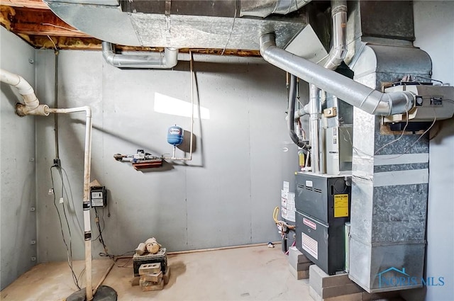 utility room featuring heating unit