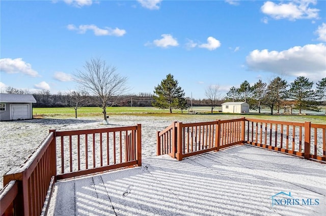 wooden deck featuring a lawn and a storage shed