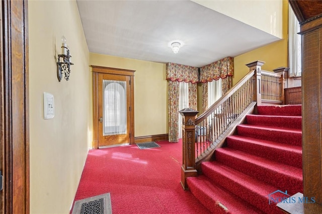 view of carpeted entrance foyer