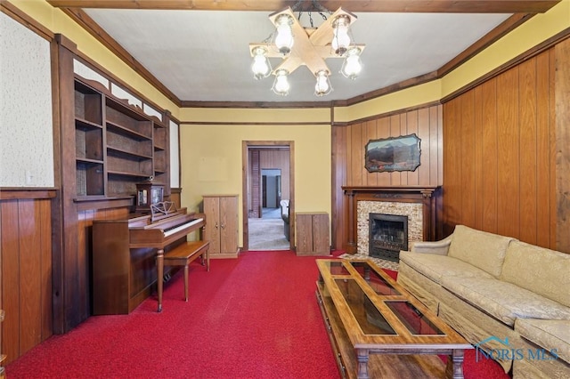 carpeted living room with an inviting chandelier, ornamental molding, and wood walls