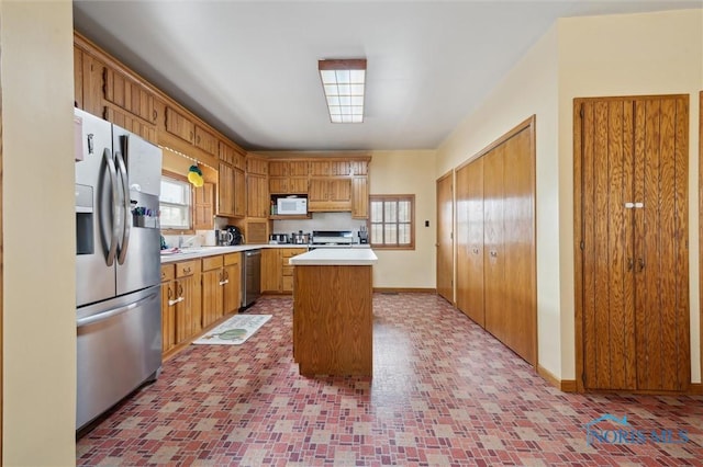 kitchen with appliances with stainless steel finishes and a center island