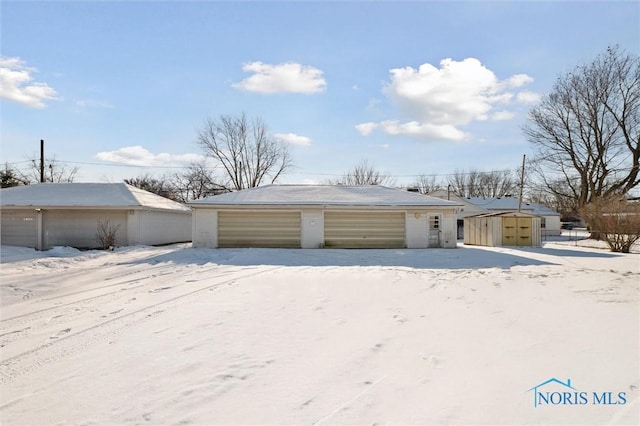 view of snow covered garage