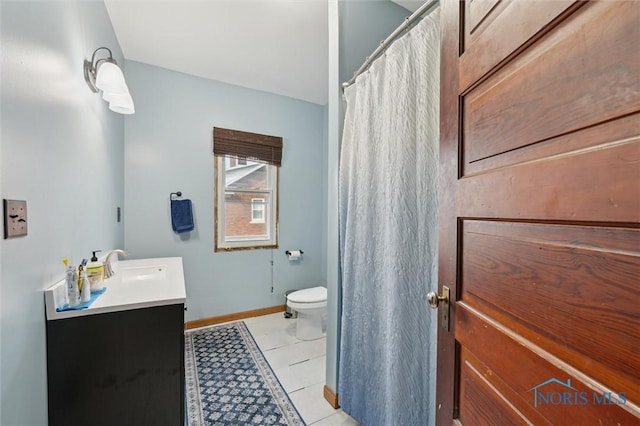 bathroom with vanity, toilet, and tile patterned flooring