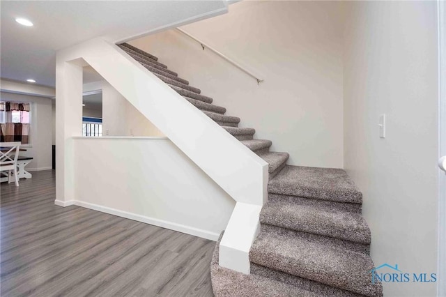 stairway featuring hardwood / wood-style flooring