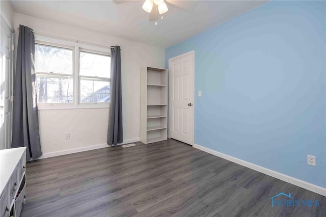 unfurnished bedroom with dark wood-type flooring and ceiling fan