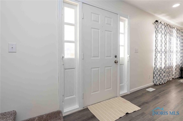 entrance foyer featuring a healthy amount of sunlight and dark wood-type flooring