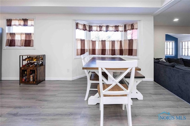 dining space with wood-type flooring