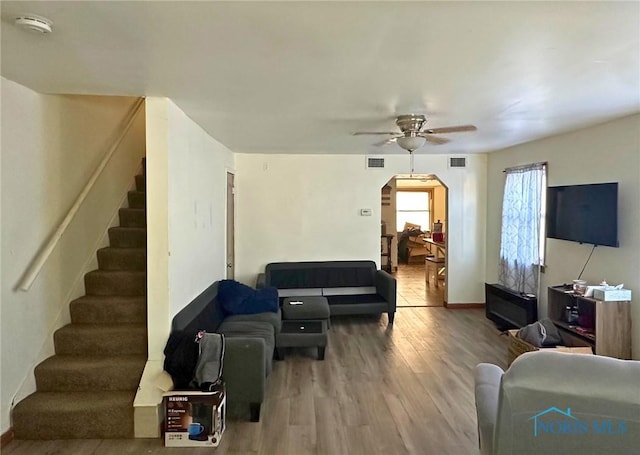 living room with ceiling fan and hardwood / wood-style floors