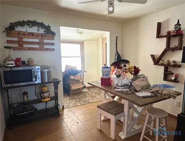 tiled dining room featuring ceiling fan