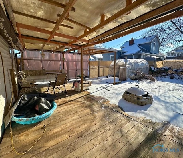 snow covered deck with an outdoor fire pit