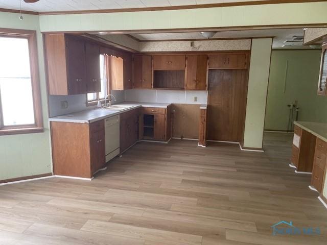 kitchen with white dishwasher, a healthy amount of sunlight, and light wood-type flooring