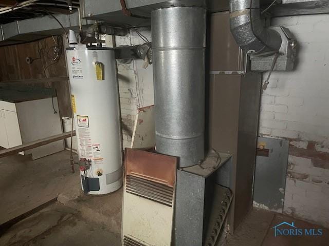 utility room featuring water heater