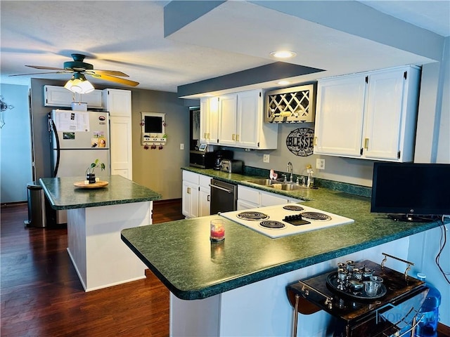 kitchen with white cabinetry, dark hardwood / wood-style floors, a breakfast bar, and sink