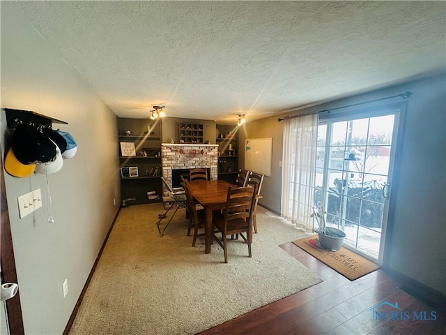 dining space featuring a fireplace and a textured ceiling