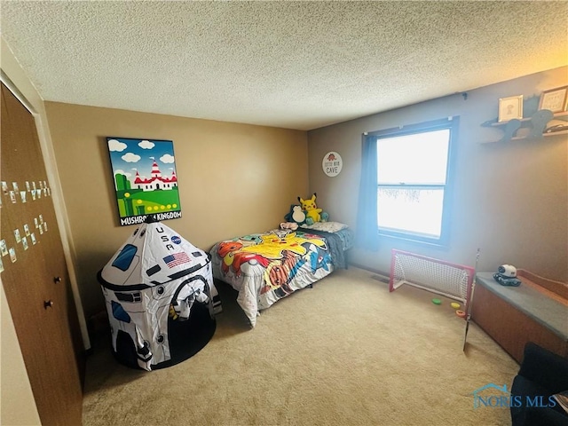 carpeted bedroom with radiator, a closet, and a textured ceiling