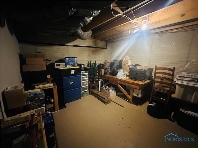 basement featuring brick wall