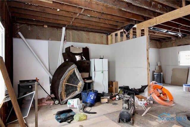 basement featuring white refrigerator