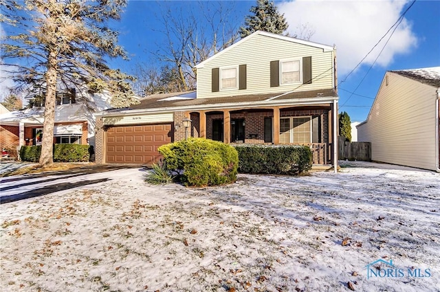 view of front property featuring a garage and a porch