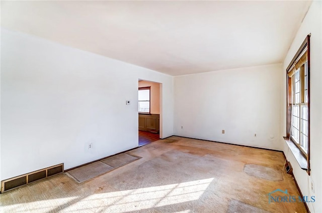 empty room featuring light colored carpet