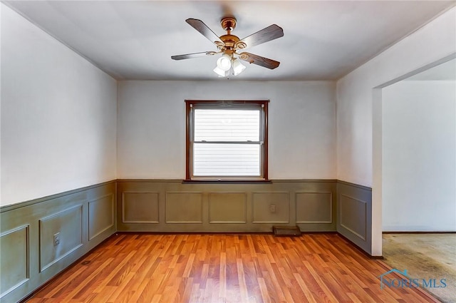 spare room featuring ceiling fan and light hardwood / wood-style floors