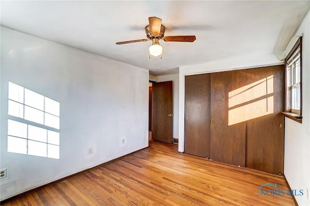 spare room featuring light hardwood / wood-style floors and ceiling fan