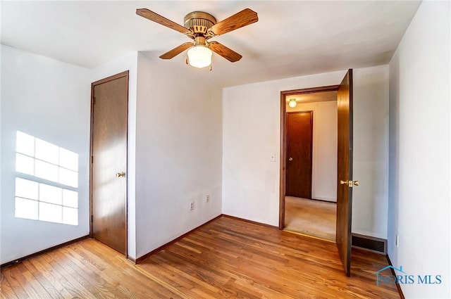 unfurnished bedroom featuring light hardwood / wood-style flooring and ceiling fan