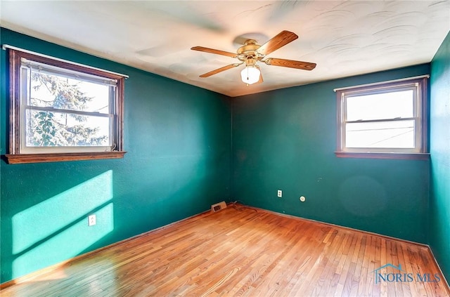 empty room with wood-type flooring and ceiling fan