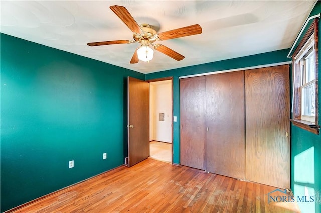 unfurnished bedroom with a closet, ceiling fan, and light hardwood / wood-style floors