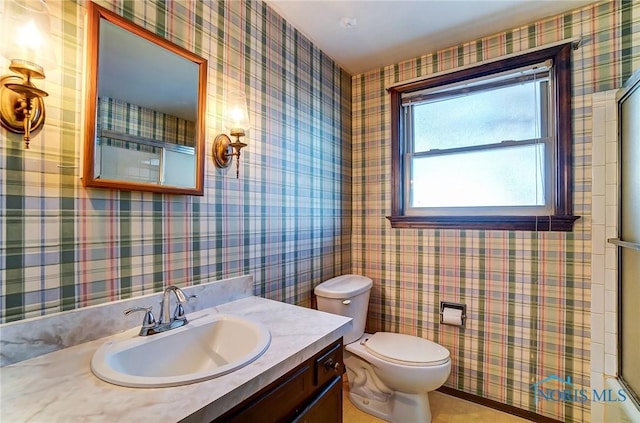 bathroom featuring toilet and vanity