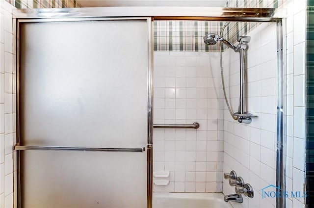 bathroom featuring shower / bath combination with glass door