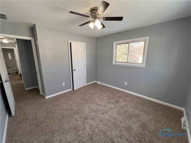 unfurnished bedroom with carpet, ceiling fan, and a closet