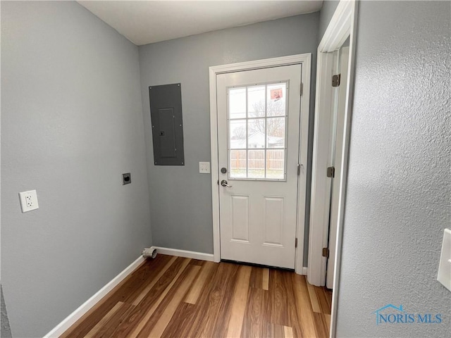 doorway featuring electric panel and light hardwood / wood-style floors