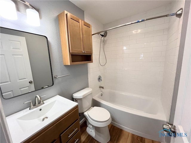 full bathroom with vanity, toilet, tiled shower / bath combo, and hardwood / wood-style floors