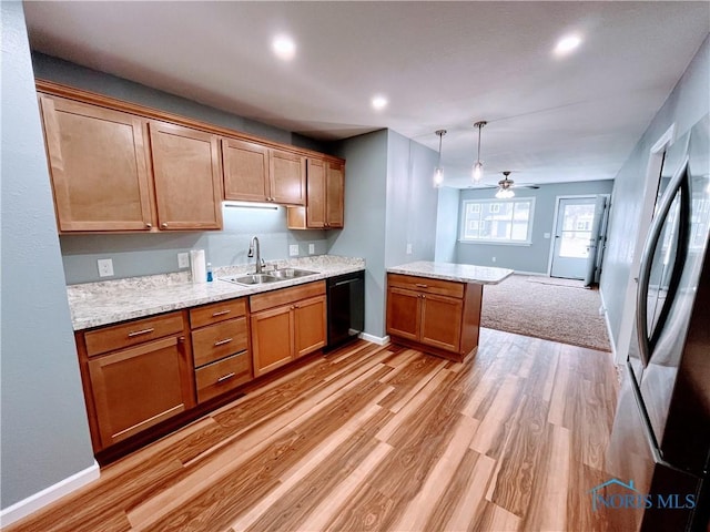 kitchen with sink, light hardwood / wood-style flooring, black dishwasher, pendant lighting, and ceiling fan