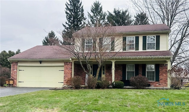 view of front of property with a garage and a front yard